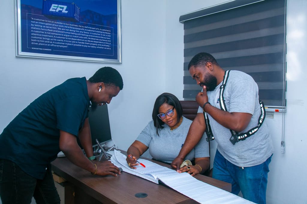 Logistics team reviewing shipment paperwork together